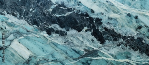 An abstract copy space image of turquoise aquamarine green black gray white natural stone texture resembling marble and granite