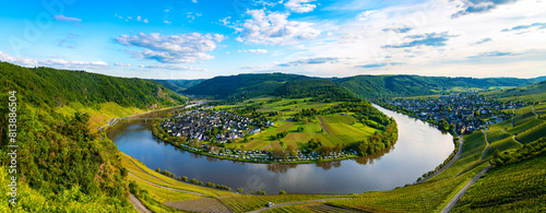 Panorama of the 180 degree river loop of the Moselle between Kröv and Traben-Trabach located in a popular wine-growing region in Germany. Wide angle perspective in the light of the evening sun in May. photo