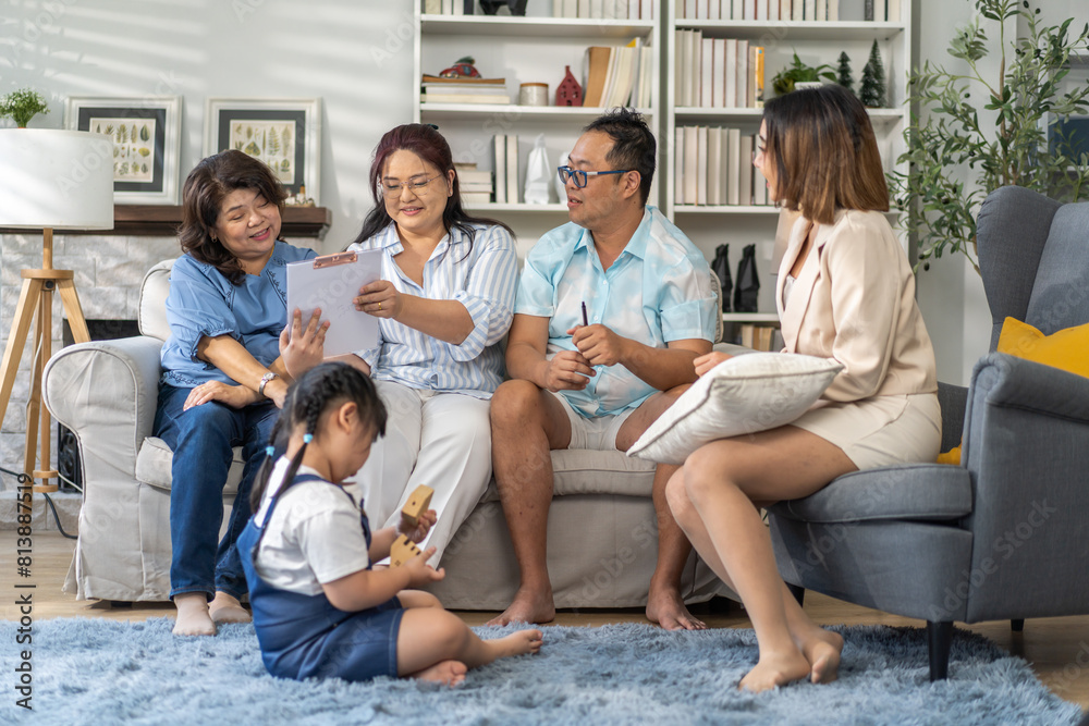 Real estate woman agent holding contract to buy and sell and life insurance to family for signature, consultant talk in house for sale.asian father signing contract.business and real estate concept Real estate woman agent holding contract to buy and sell and life insurance to family for signature, consultant talk in house for sale.asian father signing contract.business and real estate concept