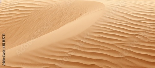 The background features a textured surface resembling sand perfect for use as a copy space image