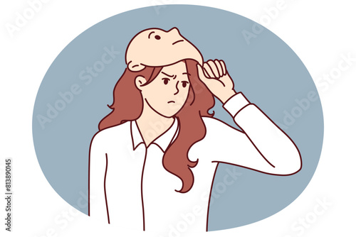 Frowning woman removes mask from face designed to hide identity or show fake emotions. Mask metaphor of lies and hypocrisy for purpose of fraud or obtaining insider information in business