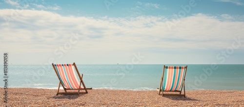 Brighton s pebble beach showing empty striped deckchairs with ample copy space image photo