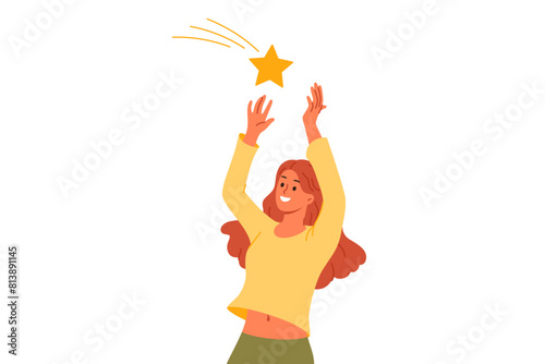 Woman catches star falling from sky and makes wish to become rich or get married. Superstitious girl watches falling stars with smile and reaches out to star in hope of good luck and fortune.