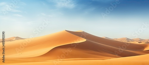 Sand dunes in Sahara Desert Africa create a beautiful and scenic landscape with vast stretches of golden sand extending into the horizon offering a copy space image