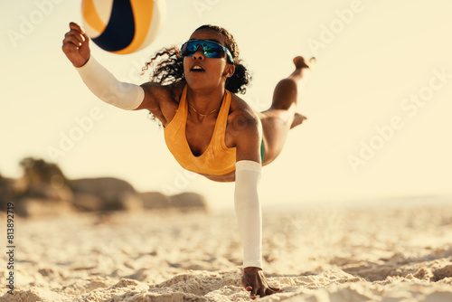 Dynamic black woman playing beach volleyball in brazil photo