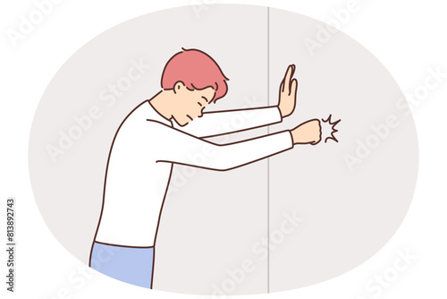 Angry man hit wall with fist