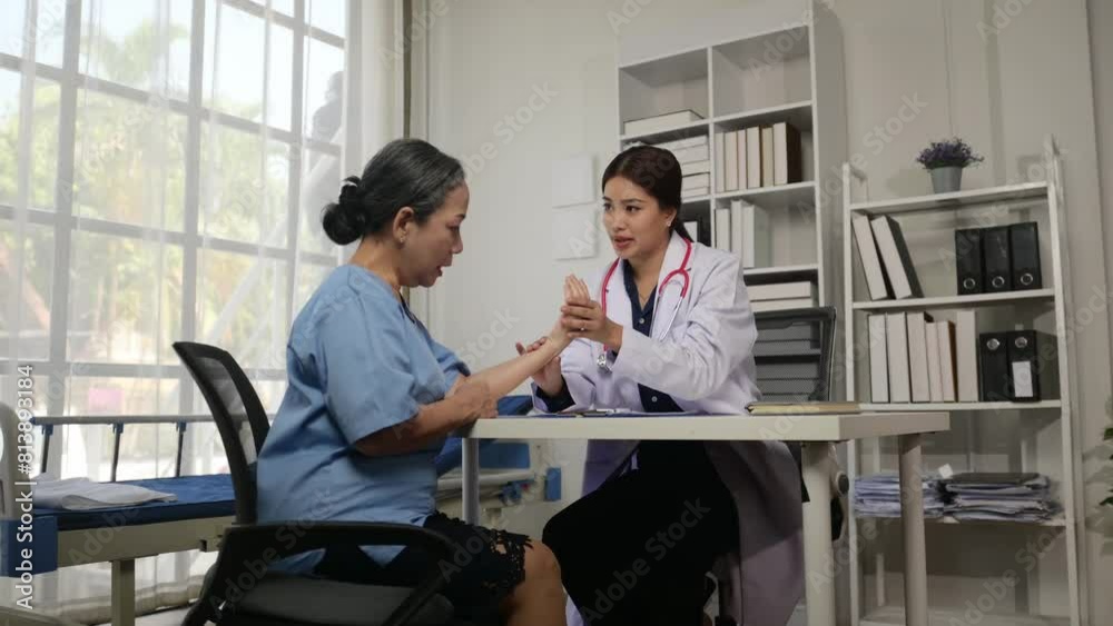 A woman in a white lab coat is talking to a woman in a blue shirt A woman in a white lab coat is talking to a woman in a blue shirt