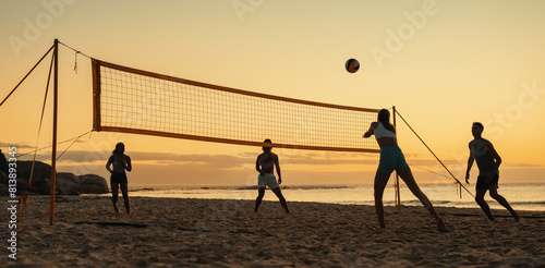 Summer games: Friendly beach volleyball match at sunset photo