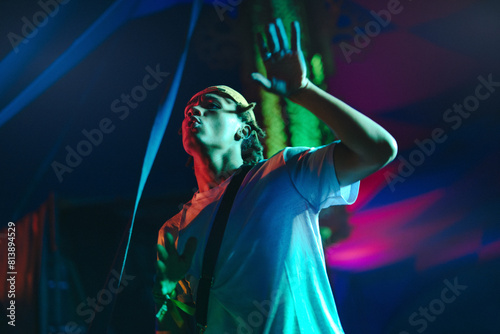 Young DJ electrifying the stage with music at a summer festival