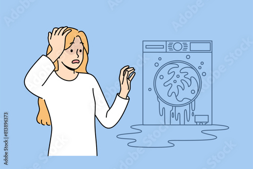 Broken washing machine shocks housewife who needs help of household appliance repairman. Breakdown of washing machine and flood in apartment are caused by lack of maintenance and clogged pipes
