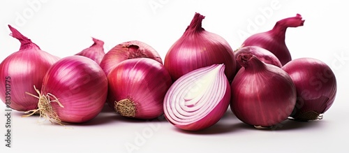 Close up isolated copy space image of a group of ripe whole and sliced red onions on a white background emphasizing the food concept