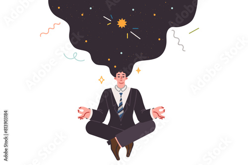 Meditating business man doing yoga thinking about space and trying to get signal from universe