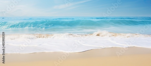 Copy space image of a gentle ocean wave caressing the sandy shoreline