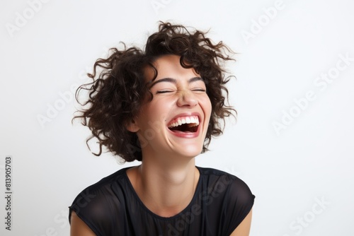 Portrait of a grinning woman in her 30s laughing on white background