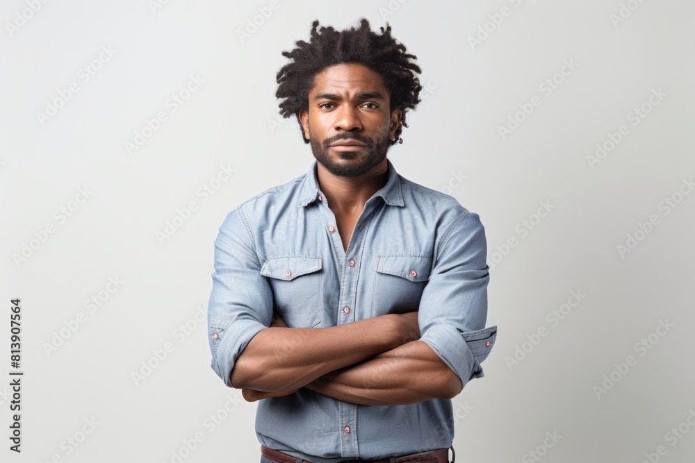 Obraz premium Portrait of a tender afro-american man in his 30s with arms crossed in white background