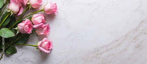 A pink rose bouquet with flower bud framings sits on a white marble table creating a captivating image with copy space It is displayed as a flat lay with a top view representing a nature themed conce photo