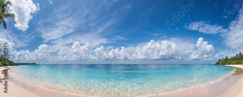 A panoramic view of a calm turquoise sea meeting a pristine sandy beach  with lush greenery in the distance under a sunny sky.