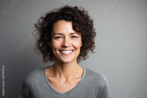 Portrait of a happy woman in her 40s smiling at the camera isolated on white background