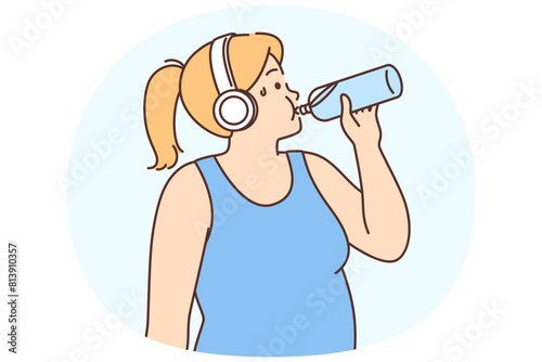 Overweight woman in headphones drink water