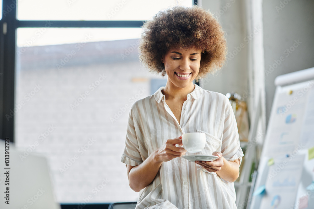 African american woman, elegant and focused, relaxes with a steaming cup of coffee in hand. African american woman, elegant and focused, relaxes with a steaming cup of coffee in hand.