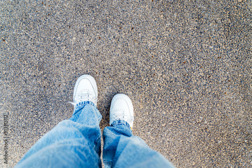 White shoes on urban grunge background of asphalt 