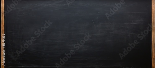 Dark wall backdrop with the texture of chalk on a blackboard or chalkboard creating a school education theme and a concept of learning Copy space image