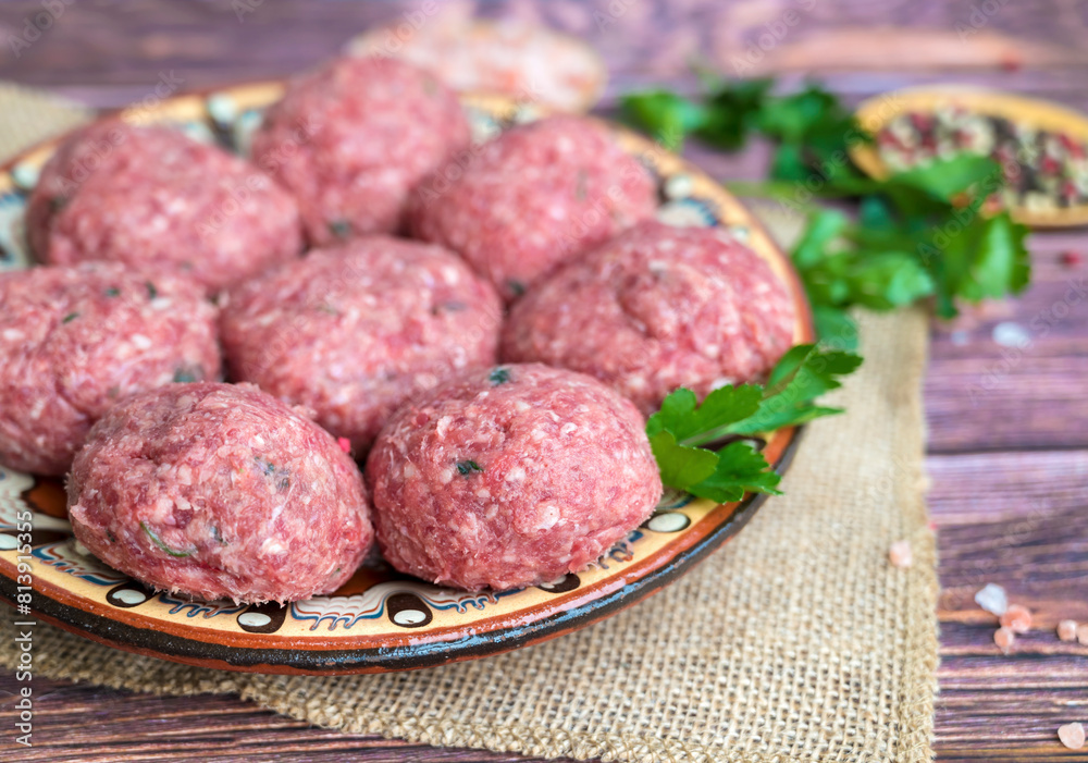 Beef raw meatballs in traditional Bulgarian plate Beef raw meatballs in traditional Bulgarian plate