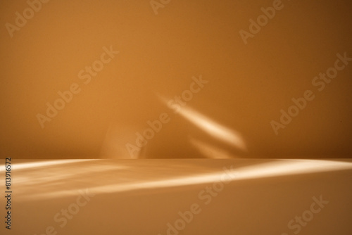 LIight reflection on smooth brown wall and empty table for branding products, presentation, food or health care..