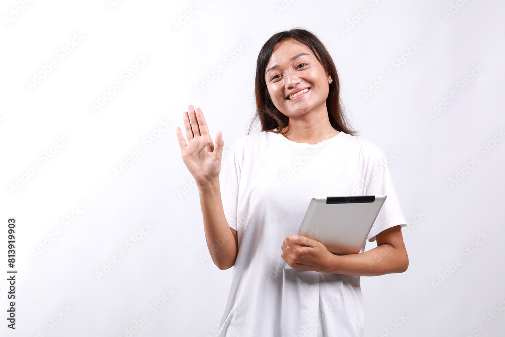 young asian female successful entrepreneurs, college student concept. Friendly smiling young woman greeting new friends. College student welcome friends with hand wave, hold computer tablet young asian female successful entrepreneurs, college student concept. Friendly smiling young woman greeting new friends. College student welcome friends with hand wave, hold computer tablet