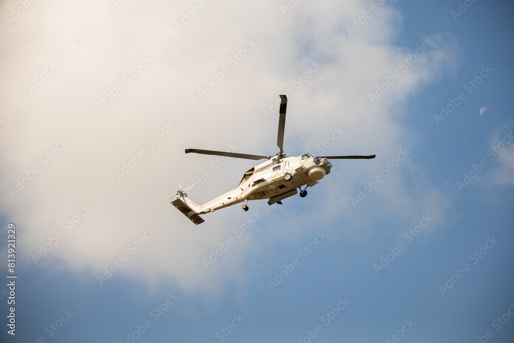 Fototapeta premium Modern helicopter in flight against blue sky. New engine technology for rescue and transport. Pilot maneuvers small aircraft with speed and precision showcasing hovering capability.
