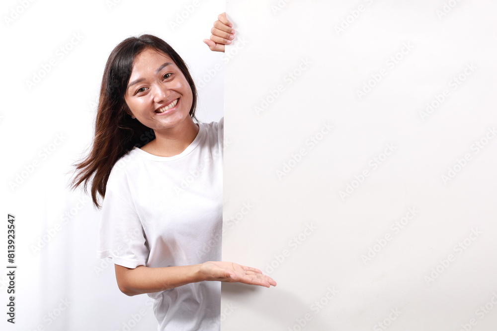 Portrait of young woman happy excited positive smile presenting empty space billboard ad advice choice isolated over white background Portrait of young woman happy excited positive smile presenting empty space billboard ad advice choice isolated over white background