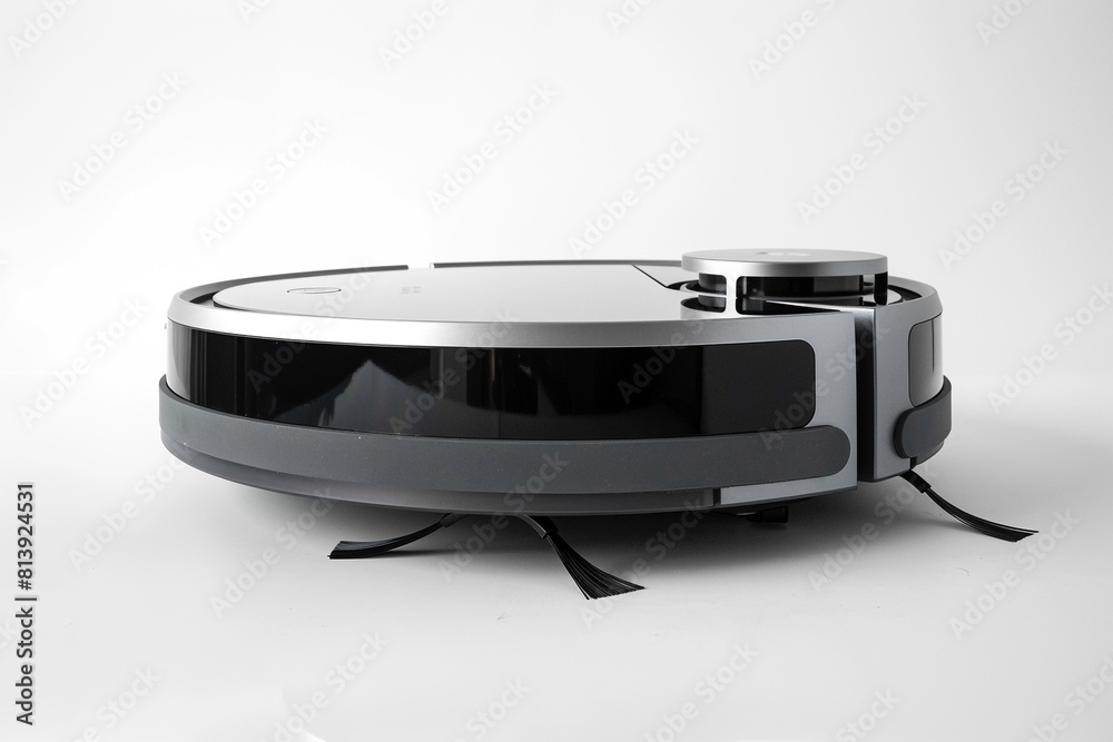 Obraz premium A sleek and compact robotic vacuum cleaner with intelligent obstacle detection and a large dustbin isolated on a solid white background.