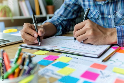 A person writing on a notebook with a pen, suitable for education or creativity concepts