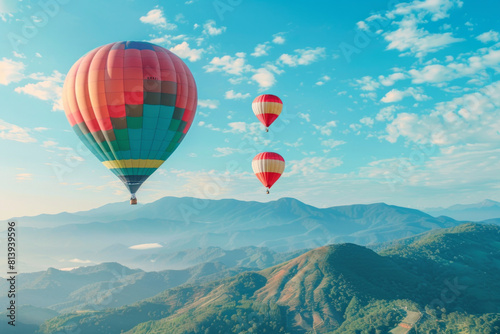 A breathtaking sight of vibrant hot air balloons drifting gracefully over a majestic mountain range, against a backdrop of clear blue skies, symbolizing adventure, and exploration © grey