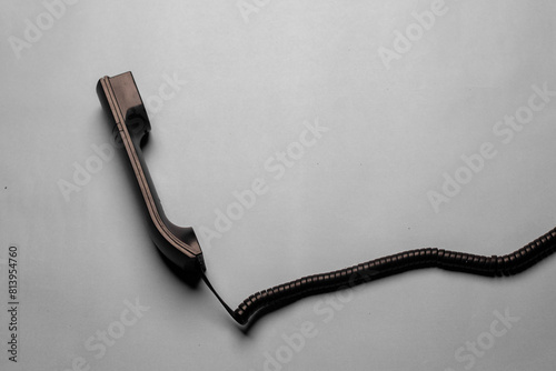 Black telephone reciever, vintage phone on a grey background photo