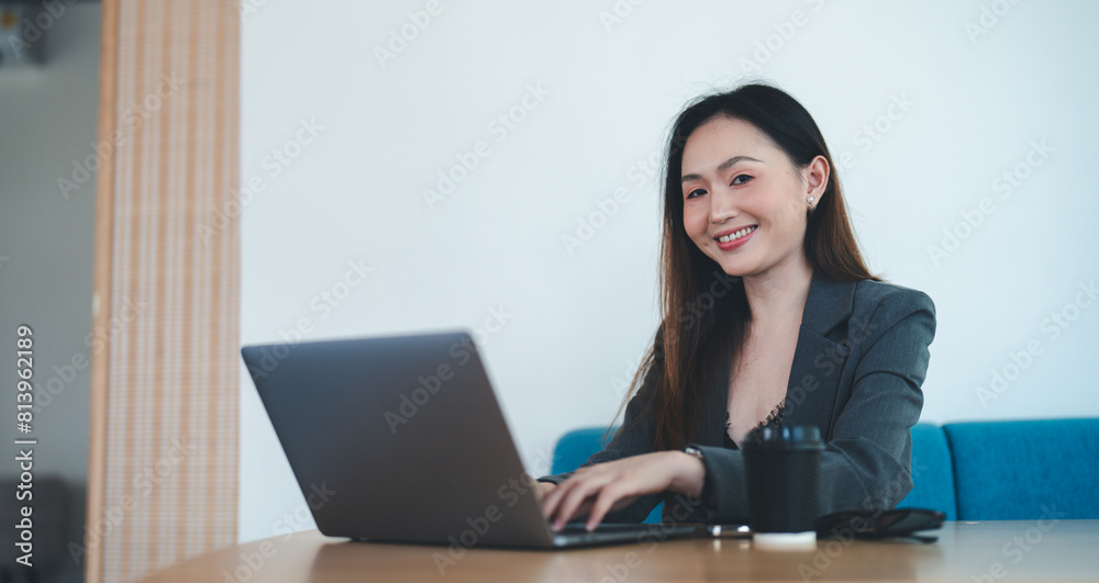Asian female office worker or businesswoman is using a laptop to work in the office. Asian female office worker or businesswoman is using a laptop to work in the office.