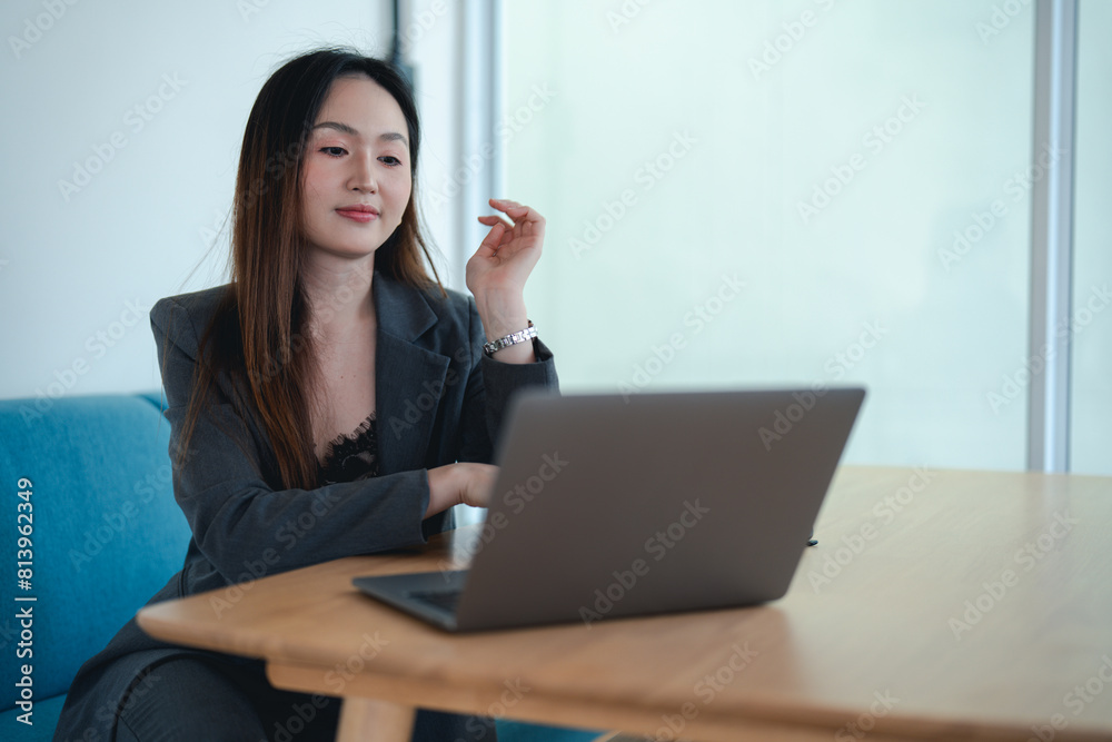 Asian female office worker or businesswoman is using a laptop to work in the office. Asian female office worker or businesswoman is using a laptop to work in the office.