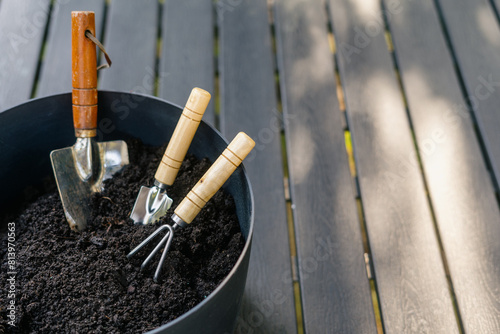 Set of gardening tools in fertile soil, close up view © brizmaker