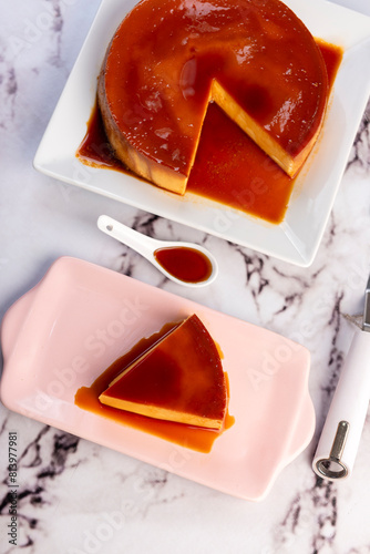 Homemade flan or Venezuelan cheese with whole caramel and in individual or large portions on white tableware