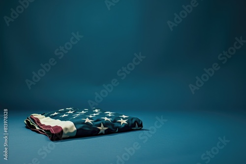 A patriotic image of a folded American flag on a blue background. Perfect for memorial day or 4th of July designs photo