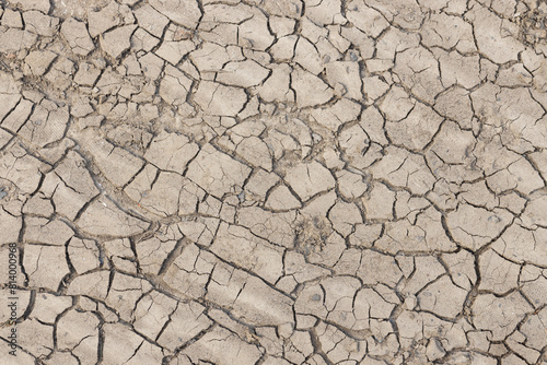 Dried cracked earth soil ground background texture. Top view