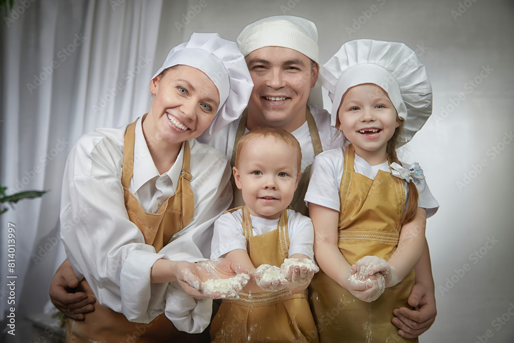 Cute oriental family with mother, father, daughter, son cooking in kitchen on Ramadan, Kurban-Bairam, Eid al-Adha. Funny family at photo shoot. Easter Cute oriental family with mother, father, daughter, son cooking in kitchen on Ramadan, Kurban-Bairam, Eid al-Adha. Funny family at photo shoot. Easter