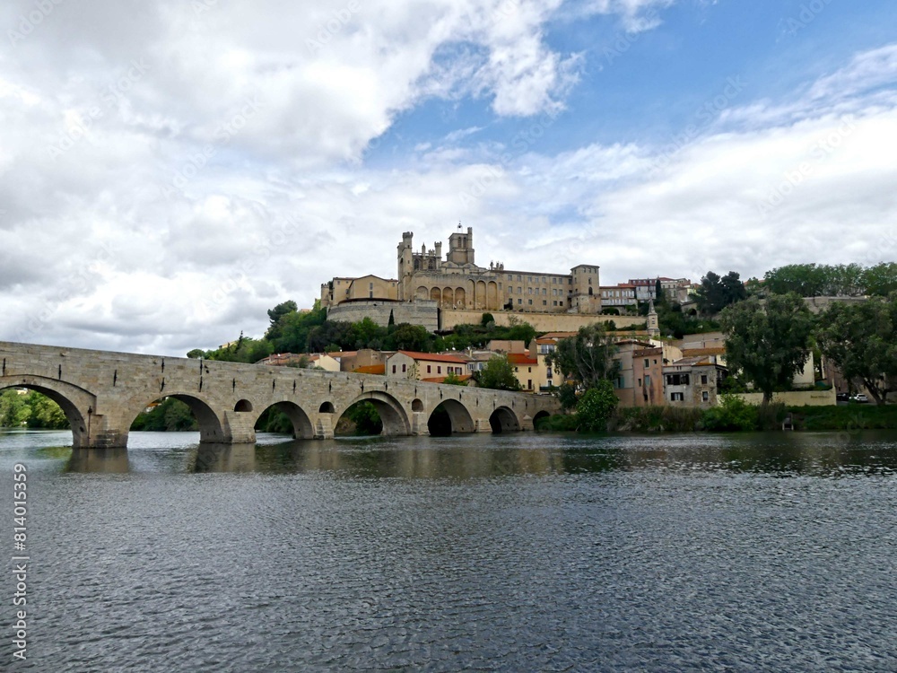 Fototapeta premium Béziers, May 2024: Visit the magnificent city of Béziers in Occitanie. Street photos - View of Saint-Nazaire and Saint-Celsus cathedrals With the Pont Vieux