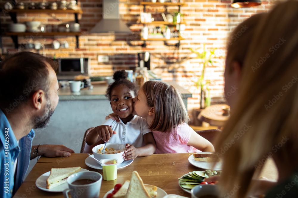 Young mixed family eating together at home Young mixed family eating together at home