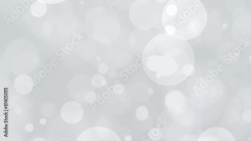 Relaxing white video background with white calmly swirling bokeh rings. Abstract white bokeh background.