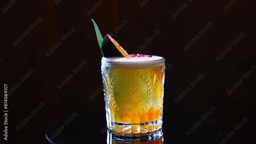 Spicy passion fruit margarita ready-to-drink in patterned glass exotic garnished with halved marakuja and bamboo leaf. Tequila based cocktail cooked with adding of lime juice and sweet puree.
