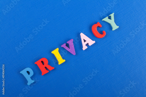 PRIVACY word on blue background composed from colorful abc alphabet block wooden letters, copy space for ad text. Learning english concept. photo