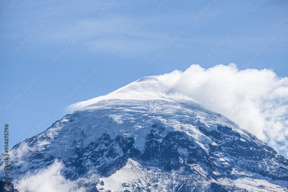 Lanin volcano surrounded by clouds, clear summit in sight and ice glaciers, between Argentina and Chile, Lanin National Park