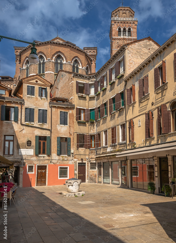 Exposure of the San Rocco Alley with the Basilica di Santa Maria Gloriosa dei Frari in the background Exposure of the San Rocco Alley with the Basilica di Santa Maria Gloriosa dei Frari in the background