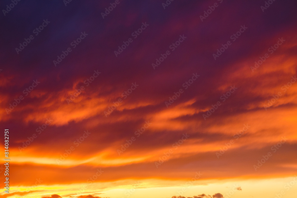 red clouds on the sky at dusk. dramatic nature background. weather change before the rain